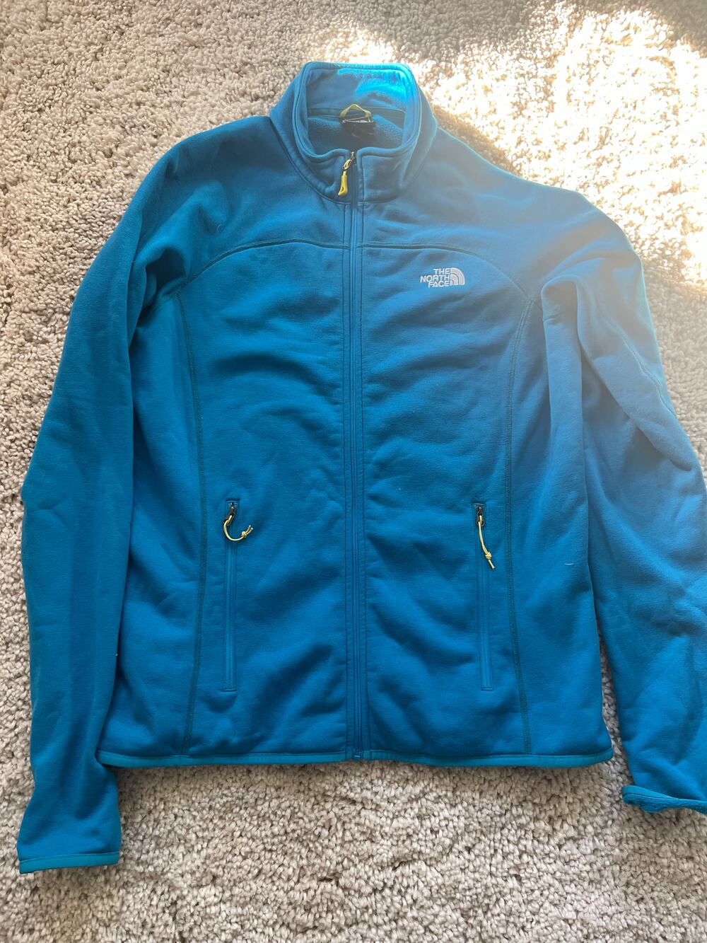 The north face blue full zip fleece jacket with zip hand pockets and stand colla